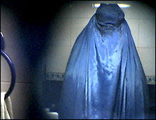 7-11-09 Circle vision CIRCLE VISION: A burqa's three-inch-wide mesh screen creates a circular grid through which a woman sees herself as a specter in a bathroom mirror. SARA TERRY