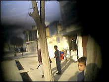 7-11-09 unique peek UNIQUE PEEK: A cell phone camera hidden under a burqa gives a unique view of the streets of Kabul. SARA TERRY