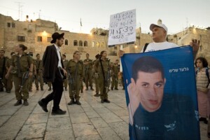 pic Gilad Shalit In this Aug. 12, 2009 file photo, an Israeli activist held a banner of Israeli soldier Sgt. Gilad Schalit at the Western Wall in Jerusalem.
