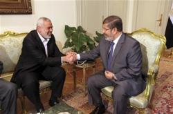 Egypt's president Mohamed Mursi meets with Senior Hamas leader Ismail Haniya at the presidential palace in Cairo