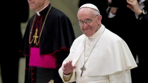 Pope Francis waves as he arrives at the Paul VI hall for a meeting with the media, at the Vatican Saturday, March 16, 2013. (AP Photo/Alessandra Tarantino)