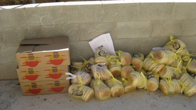 Parcels of bread collected from settlements await distribution in the Palestinian village of Sawiyah Monday (photo credit: courtesy/Yaki Fried)
