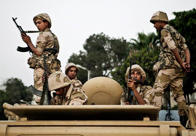 VIRGINIE NGUYEN HOANG/AP An Egyptian military convoy arrives at the Kasr El-Nile Bridge near Tahrir Square on July 5 to keep order in Cairo.