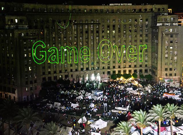 KHALED DESOUKI/AFP/GETTY IMAGES Laser lights beam 'Game Over' onto a government building by Tahrir Square on July 2 as Egyptians rally to demand the ouster of their first democratically elected president, Mohammed Morsi.