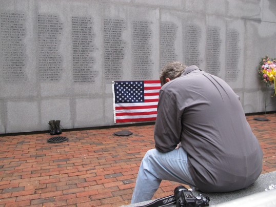 Ed Ayers in front the wall etched with the names of 241 Americans