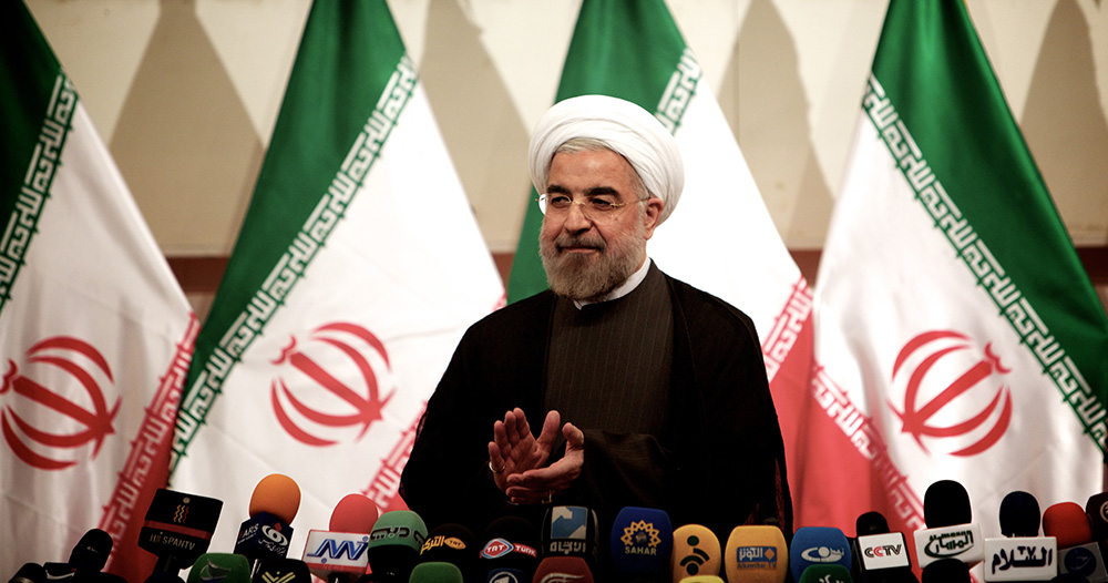 Iranian President Hassan Rouhani claps during a press conference in Tehran. (Behrouz Mehri/AFP/Getty Images)