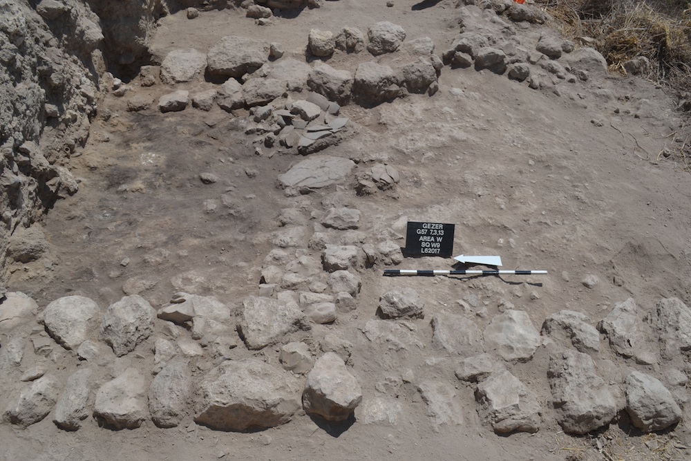 Burned ruins and fired mudbrick collapse, as well as smashed pottery, reveal the late Bronze Age destruction at the city. On the left is the room where several pottery vessels, a scarab of Amenhotep III, a cache of cylinder seals, as well as stone implements were found. Credit: Samuel Wolff, Tel Gezer Excavations