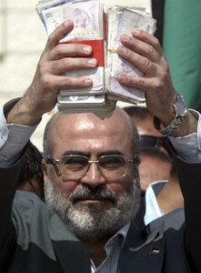 In Gaza, too, cash is still king. Hamas deputy prime minister Ziad al-Zaza holds up British pounds received from British MP George Galloway on March 10, 2009. Photo: Abed Rahim Khatib / Flash90
