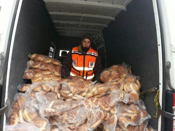Photo of United Hatzolah volunteers now handing out free Challas for whoever didn't get any yet on Surei Yisroel St