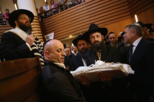 An infant being carried before his circumcision at an Orthodox synagogue in Berlin in 2013. (Sean Gallup / Getty Images)