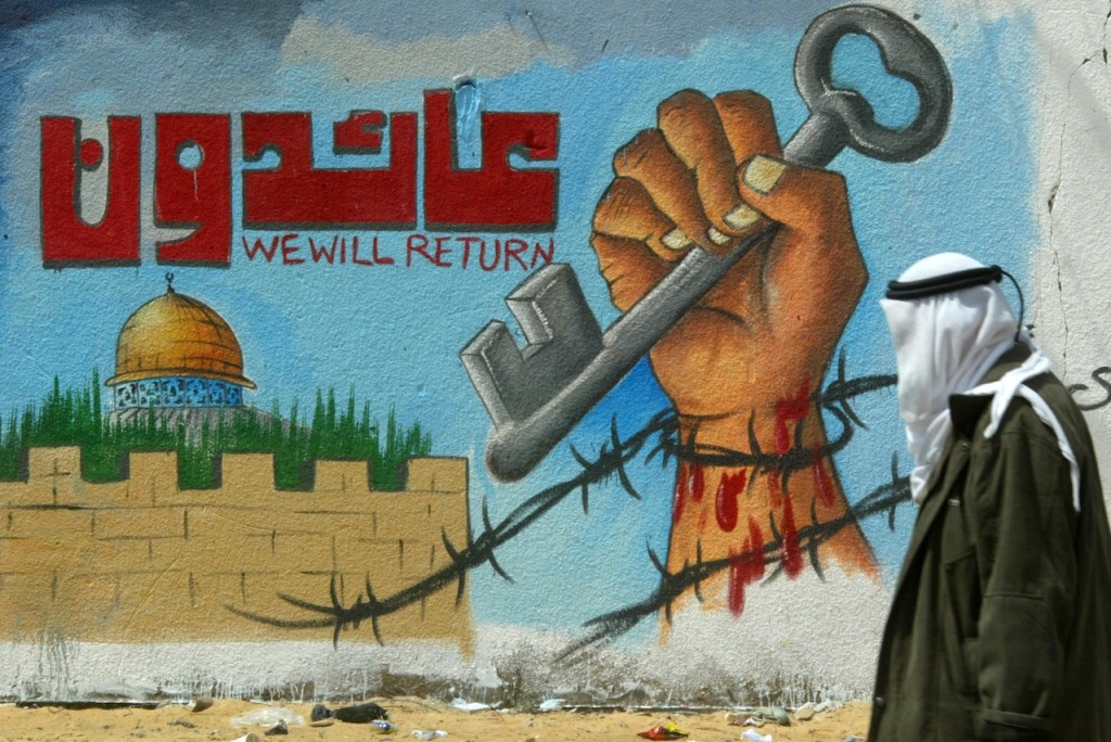 A Palestinian man walks in front of a mural calling for the return of Palestinian refugees on May 14, 2011 in Rafah in southern Gaza during a gathering to mark the 63th anniversary of what Palestinians call the Nakba, or the “catastrophe” of Israel’s founding. (Abed Rahim Khatib/Flash 90)