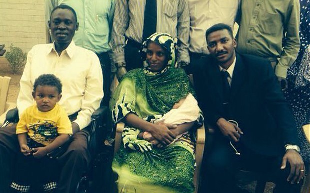 Meriam Ibrahim holding her baby daughter Maya, with her legal team and, left, husband Daniel Wani and son Martin