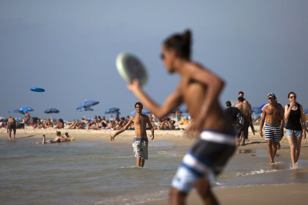Israelis enjoy the Mediterranean Sea air in Tel Aviv, on Aug. 29, 2013. Author Michael B. Oren writes that in today's Israel, 'The beaches are teeming, the rock music is awesome, and the food is off the Zagat charts.'