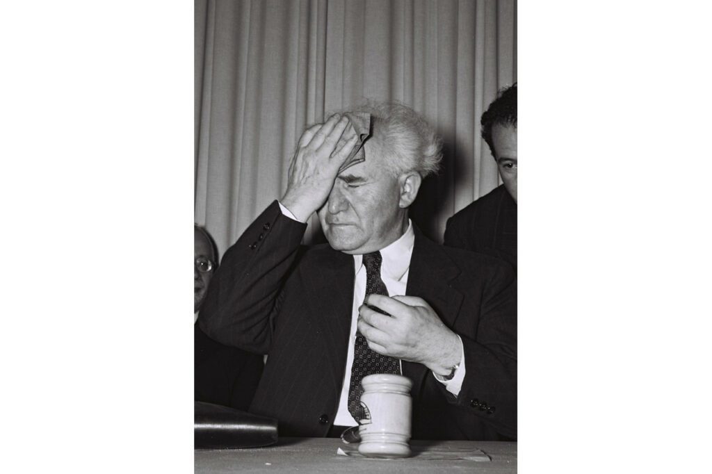 Israel's first prime minister, David Ben Gurion, mops his forehead just before he stands up to read out Israel's Declaration of Independence in Tel Aviv, on May 14, 1948. Ben Gurion, a Polish immigrant, was Israel's founding father, leading the Jewish state through the 1948-49 War of Independence and the 1956 Suez War.
