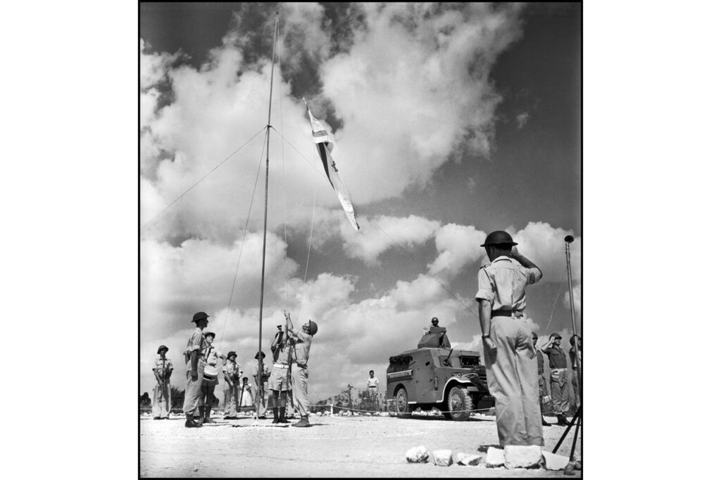 Israelis hoist their new flag at a ceremony in 1948.