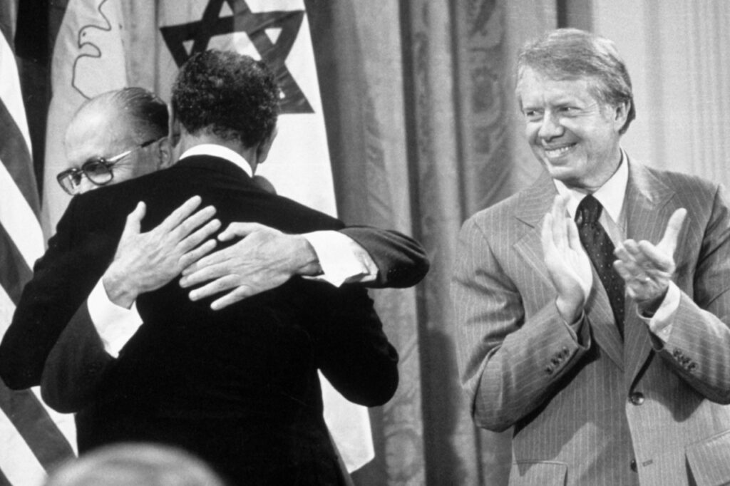 As President Jimmy Carter applauds, Israeli Prime Minister Menachem Begin and Egyptian President Anwar al-Sadat embrace in the East Room of the White House after the signing of a 'Framework for Peace' in the Middle East, on Sept. 17, 1978. Mr. Sadat's visit to Jerusalem in 1977 led to the U.S.-brokered Camp David accords in 1978, followed by Israel's first peace treaty with an Arab state the following year.