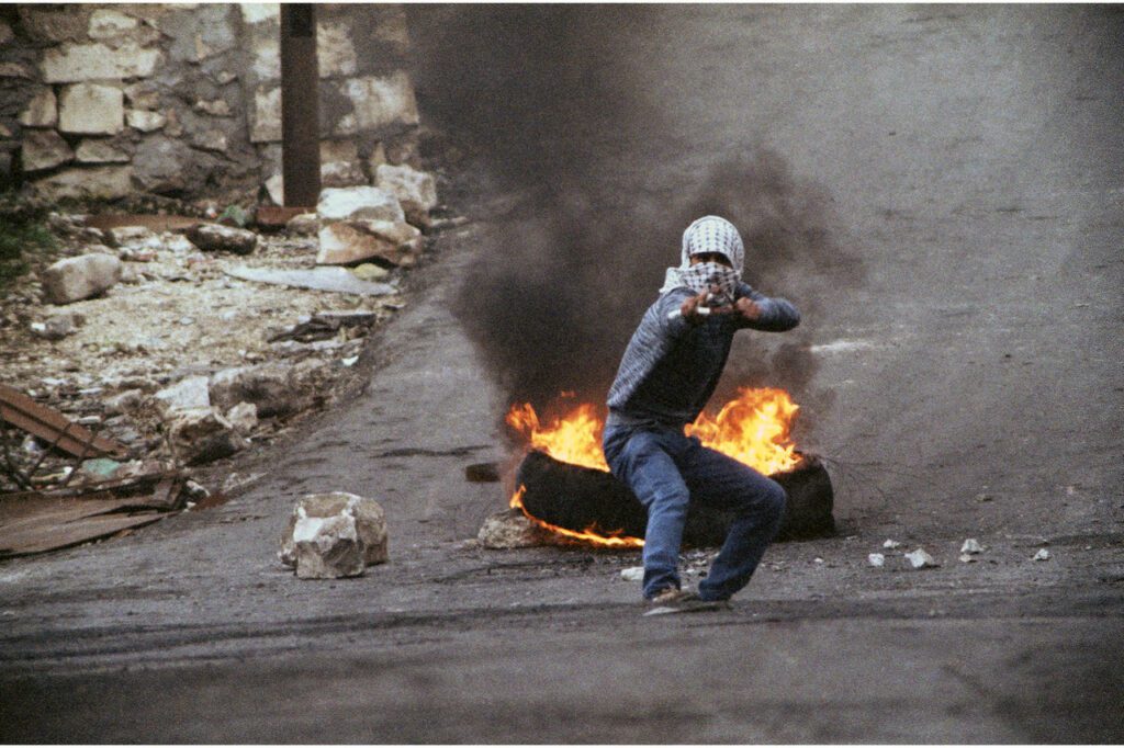 In 1987, a Palestinian uprising erupted in the Israeli-occupied West Bank and Gaza, jolting many Israelis into revisiting the question of whether the Jewish state could indefinitely control those areas. A Palestinian teenager, armed with a slingshot and using marbles for ammunition, takes aim at Israeli soldiers in the West Bank town of Nablus, Jan. 14, 1988.