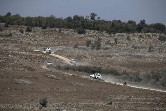 U.N. vehicles drive in Syria near the border fence with the Israeli-occupied Golan Heights September 2, 2014. Credit: Reuters/Baz Ratner