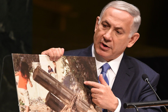 Israeli Prime Minister Benjamin Netanyahu holds up a photo said to be of a Hamas rocket as he addresses the 69th session of the United Nations General Assembly on Monday. Agence France-Presse/Getty Images