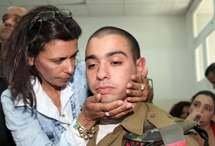 Sgt. Elor Azariya is hugged by his mother
