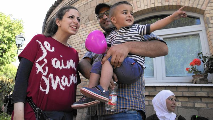 Refugees Nour Essa, husband Hasan Zaheda and son Riad are among the 12 Syrians plucked from a Greek camp by Pope Francis and placed with the charity Sant’Egidio in Rome’s Trastevere neighborhood. (Alessandra Tarantino / Associated Press)