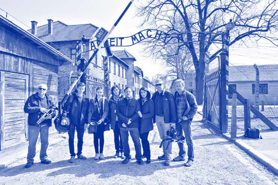 ZLM crew standing in front of death camp gate