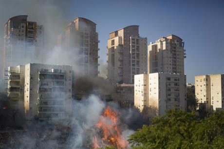 A fire burns in Haifa, Israel, Thursday, Nov. 24, 2016. Israeli police have arrested four Palestinians in connection with one of several large fires that damaged homes and prompted the evacuation of thousands of people in the past few days. Police are investigating the causes, including possible arson. Windy and hot weather have helped fan the flames. The blazes started three days ago near Jerusalem and in the north. Hundreds of homes were damaged. Russia, Italy and other countries are assisting the Israeli firefighters.(AP Photo/Ariel Schalit)