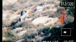 A photograph of a camera showing what appears to be a Palestinian man starting a fire in a field near Battir, outside of Bethlehem on November 26, 2016. (Parks Authority)